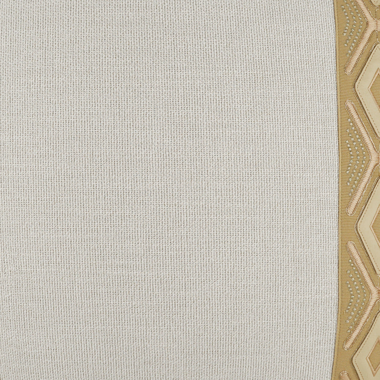 Beige woven fabric with a gold geometric border along the right edge.