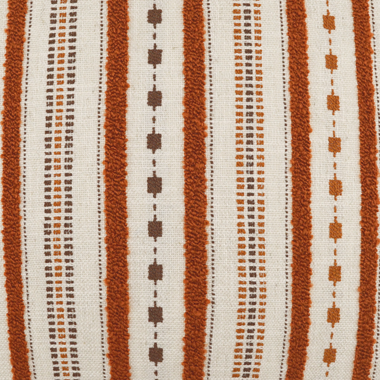 Rust orange and cream striped woven fabric with vertical bands of squares and dotted rows.