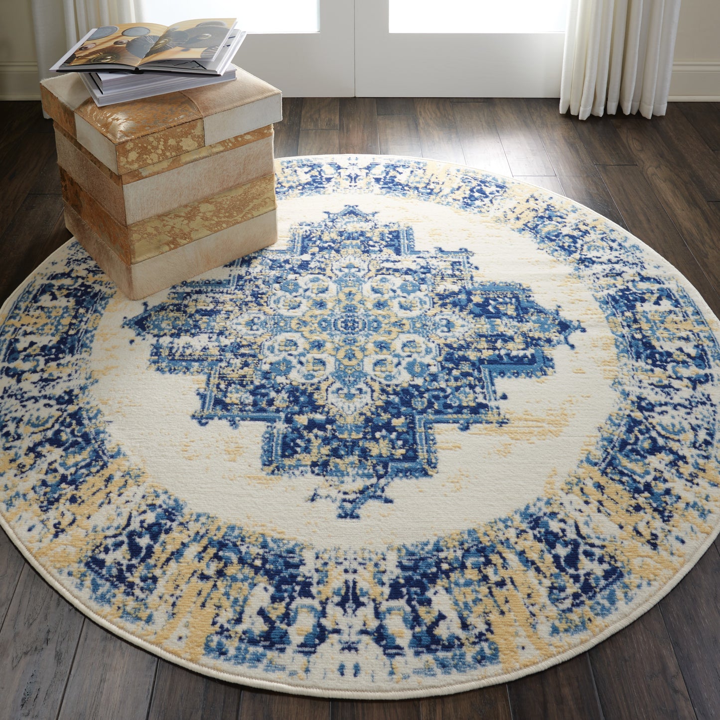 Round blue and ivory oriental rug with a detailed beige medallion pattern, ideal for living room decor.