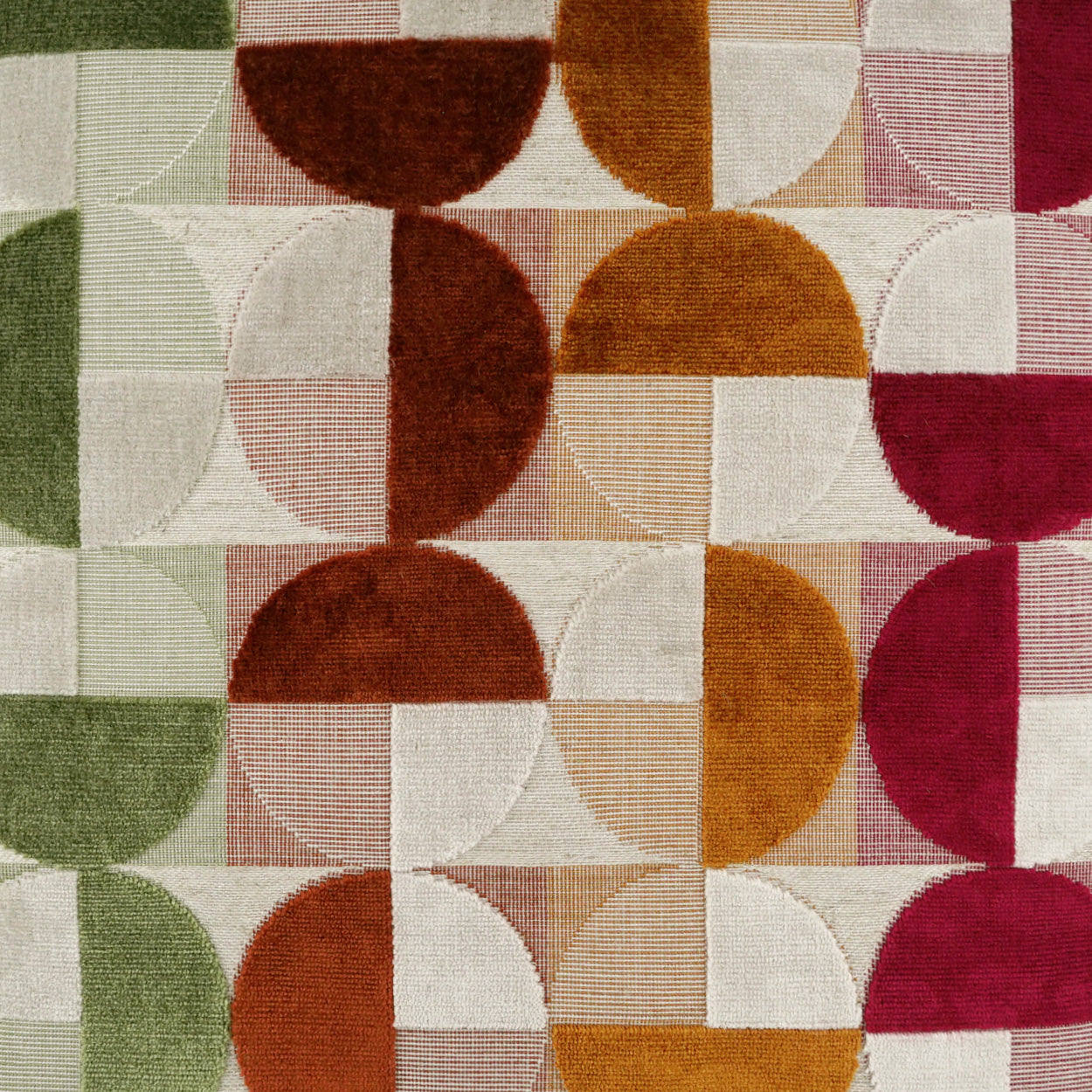 Mid-century modern geometric quilt fabric with half-circles and squares in greens, browns, oranges, beiges and pinks.