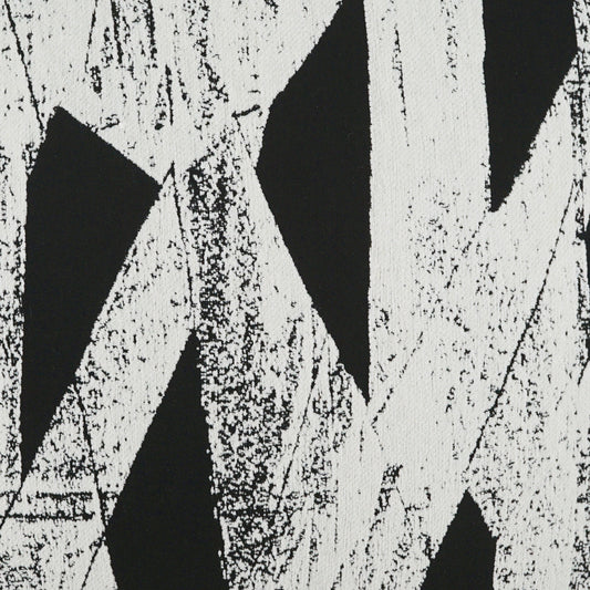 Black and white geometric fabric print with bold diagonal shapes and distressed texture.
