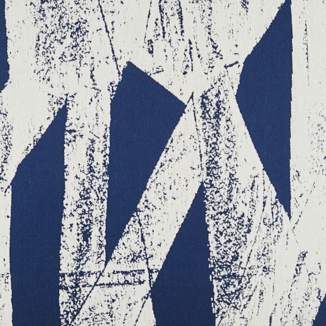 Blue & white geometric fabric with bold triangle shapes on a textured background.