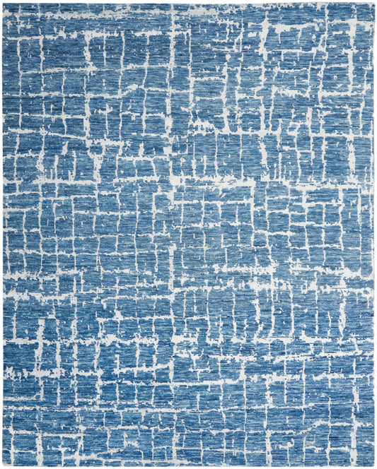 Blue and white distressed area rug with a cracked, grid-like pattern; modern contemporary style.