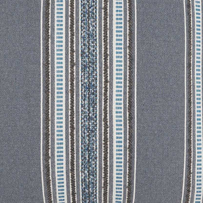 Pillow covered in woven fabric with vertical indigo, gray, white and black stripes; textured weave and varied stripe widths.