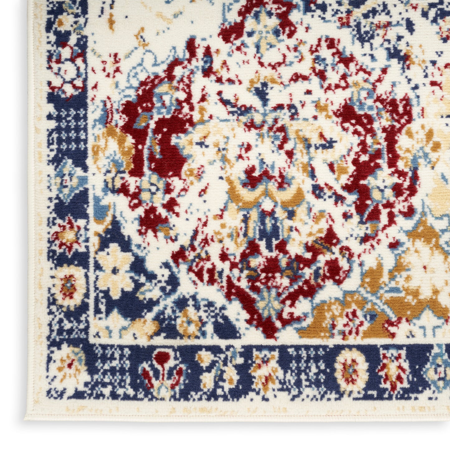 Close-up of a Persian-style area rug: ivory field with red and gold floral medallion, navy border.