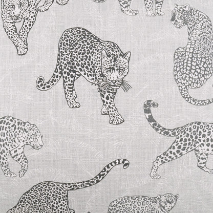 Light grey linen fabric with black leopard silhouettes in a repeating pattern on a 24" x 24" pillow.