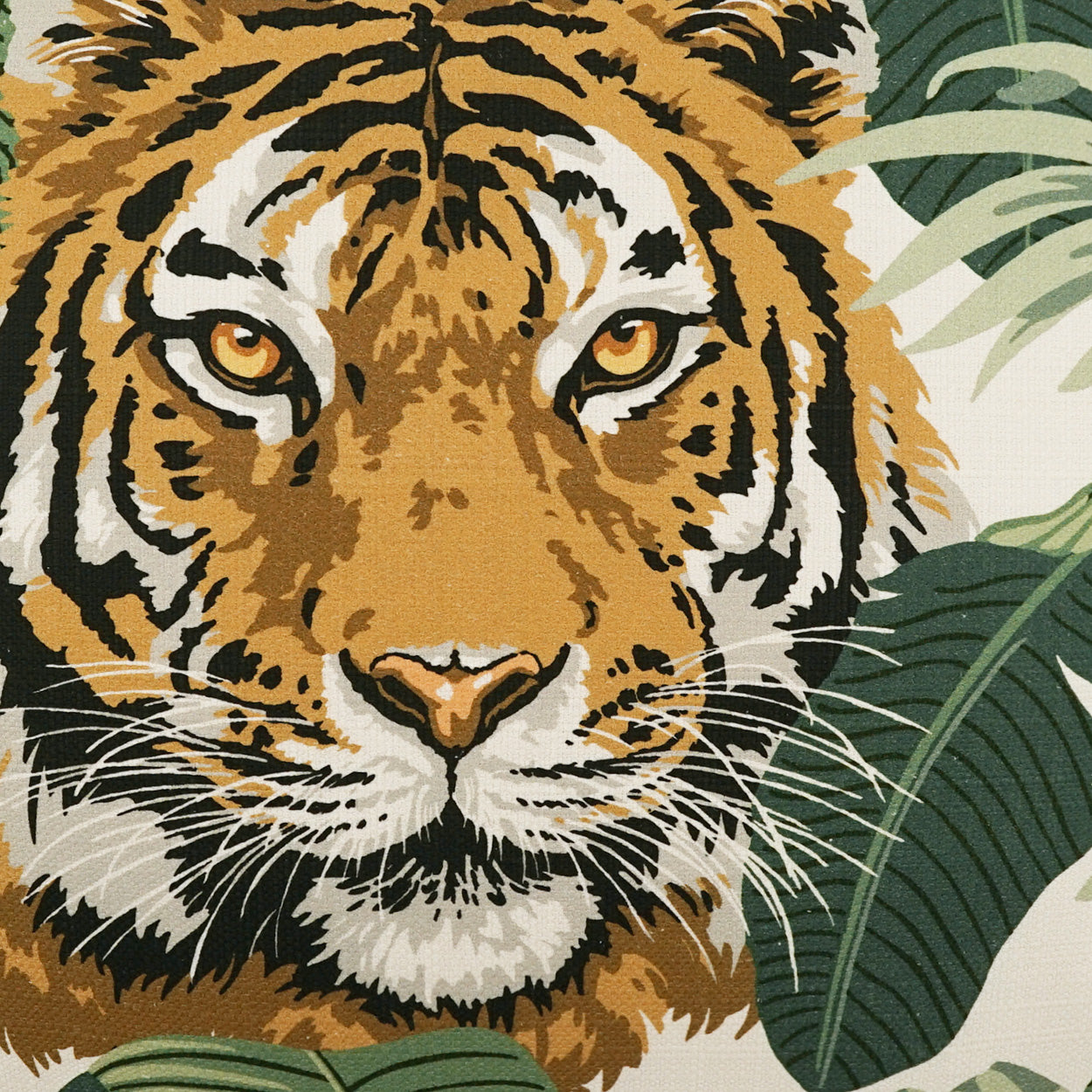 Tiger face fabric print: orange fur with black stripes, white muzzle, set against green tropical leaves.