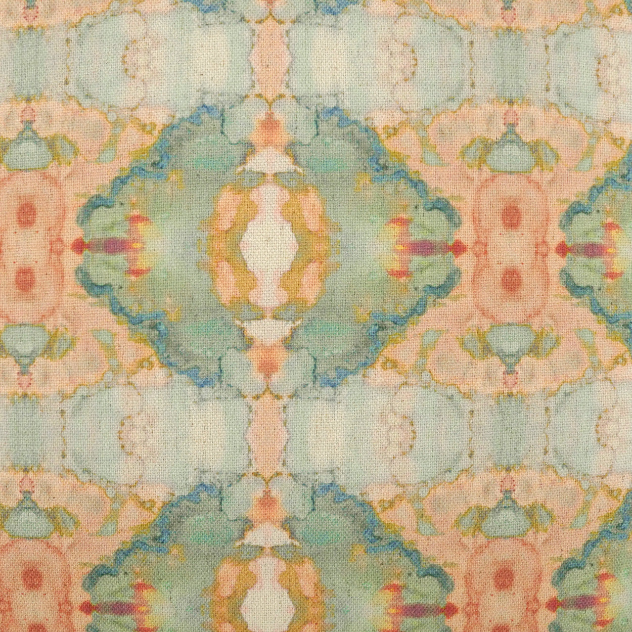 Pastel ikat-inspired fabric with mint, peach, teal and pink hues in a symmetric repeating motif.