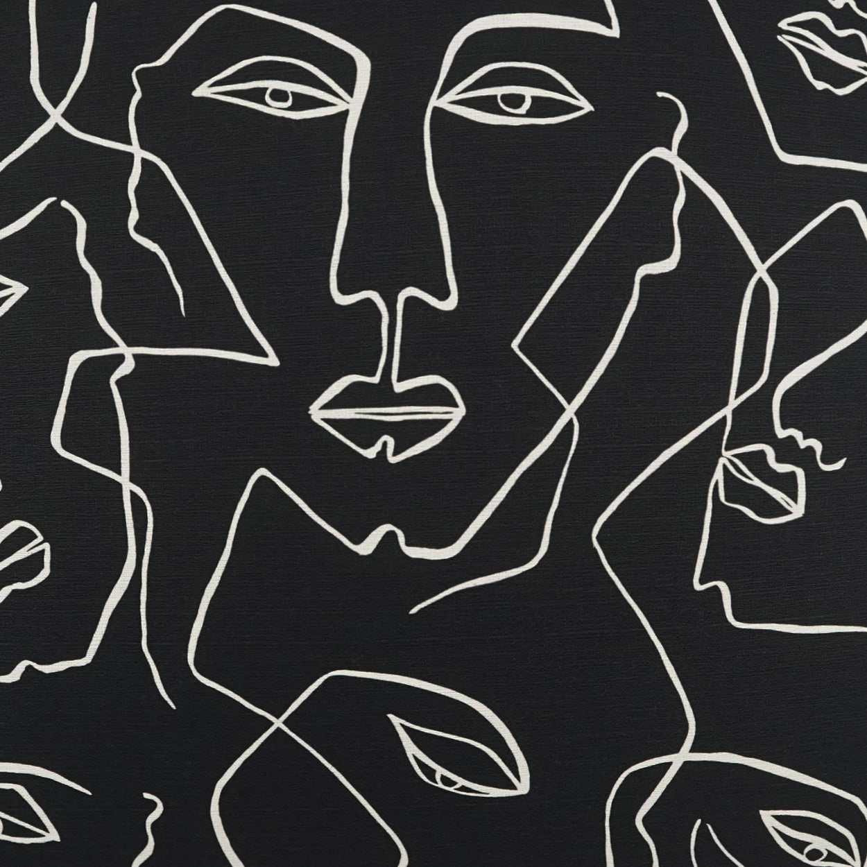 Monochrome fabric with white continuous-line abstract faces on black background; modern art textile print.
