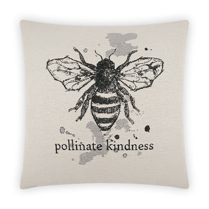 Beige linen-look pillow with a black hand-drawn bee, ink splatters, and 'pollinate kindness' text.