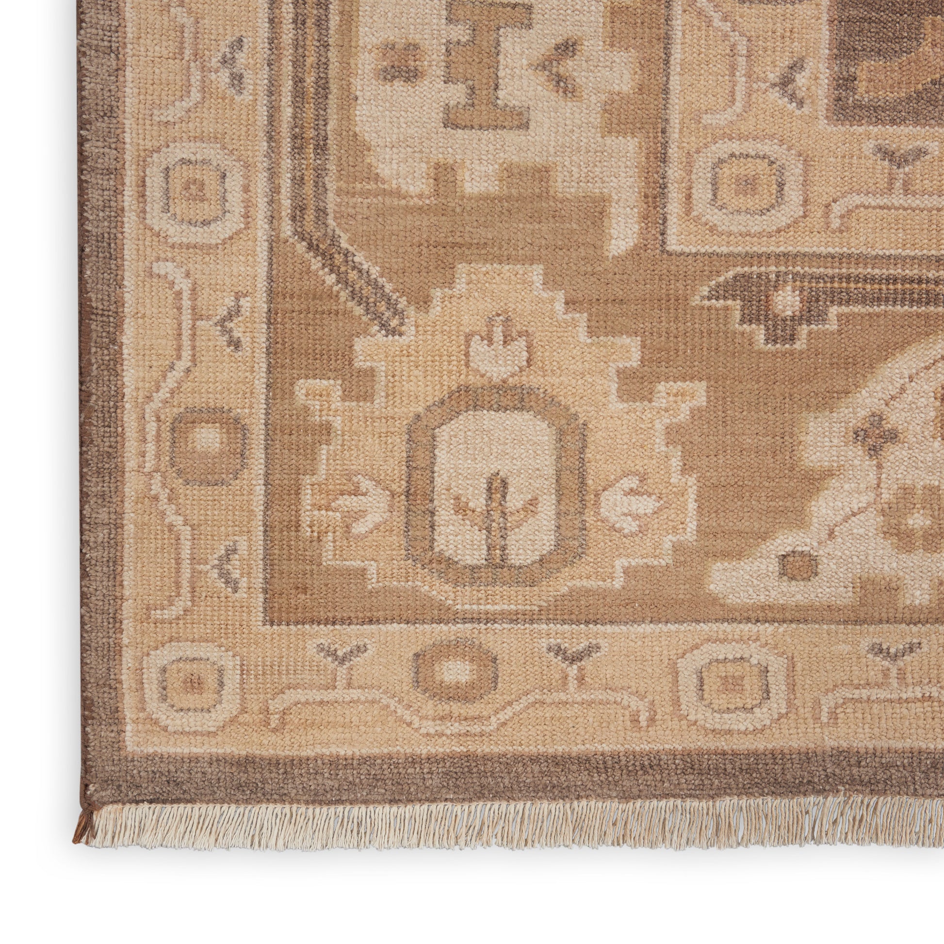 Beige-brown oriental wool rug with geometric motifs and fringed edge.