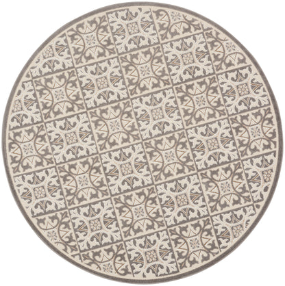 Round ceramic plate with cream and gray tile motif and ornate floral patterns in a repeating grid.