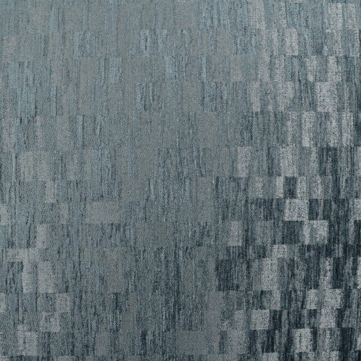 Blue-gray fabric texture with a pixelated, checkered pattern of small rectangular blocks.