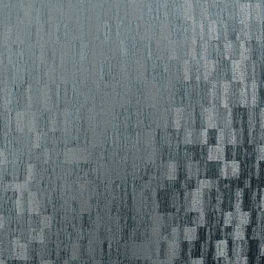 Blue-gray fabric texture with a pixelated, checkered pattern of small rectangular blocks.