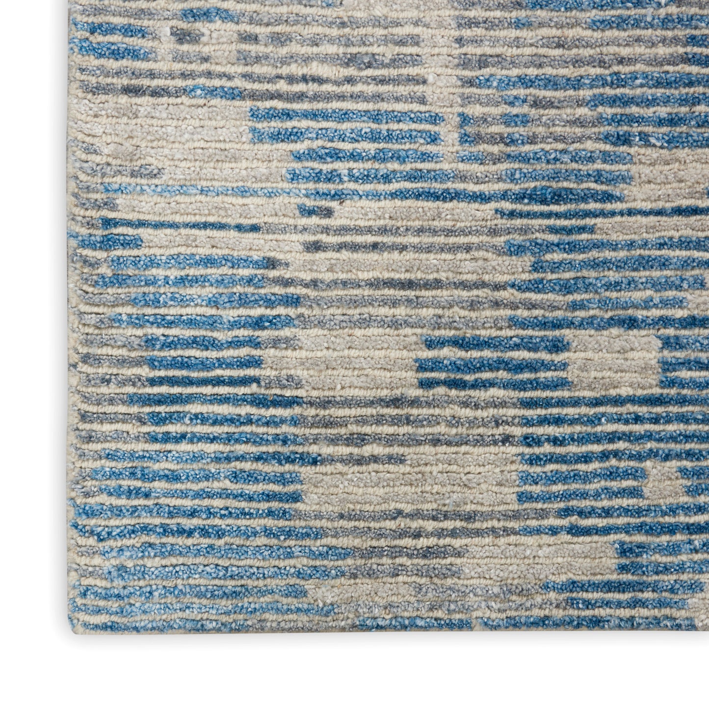 Blue and cream abstract-pattern area rug with a textured woven pile.