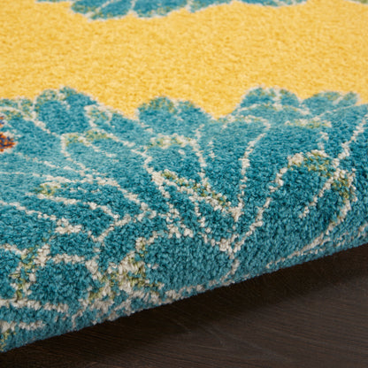 Close-up of a blue and yellow shaggy area rug with thick pile and abstract pattern.
