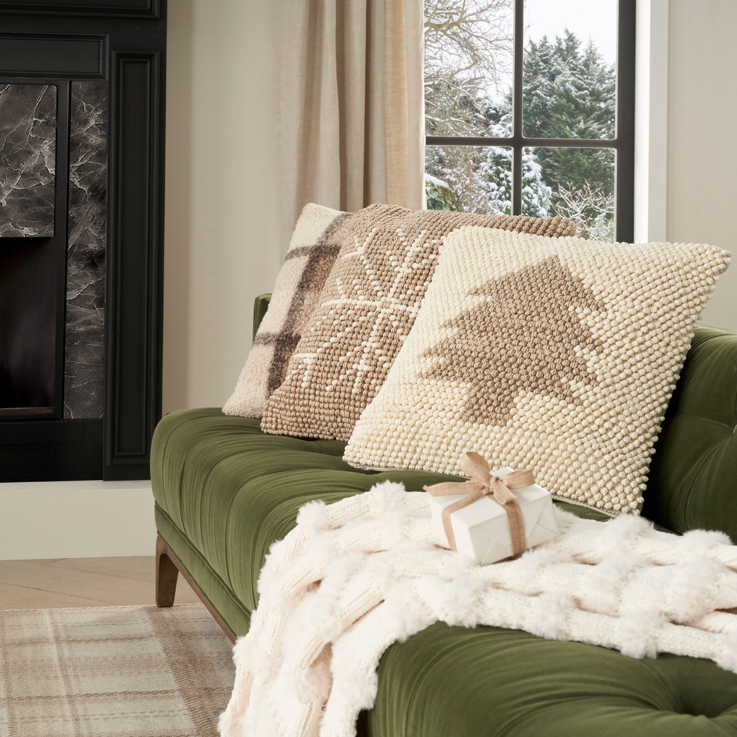 Green rug with beige geometric pattern and subtle texture, set on a snowy window scene.
