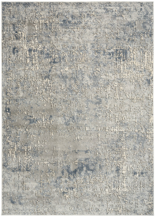 Muted blue-gray and beige distressed abstract rug, soft textured surface, rectangular for living room decor.