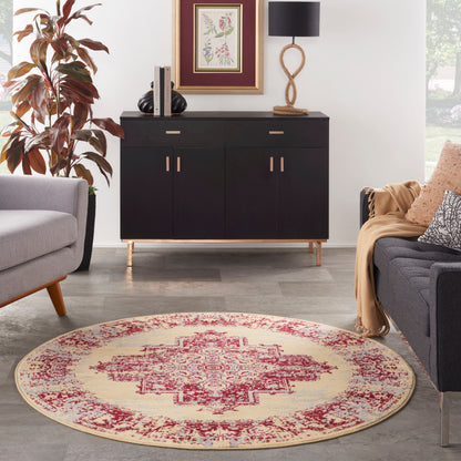 Round beige vintage rug (5' diameter) in a modern living room with gray seating, a plant, and framed art.