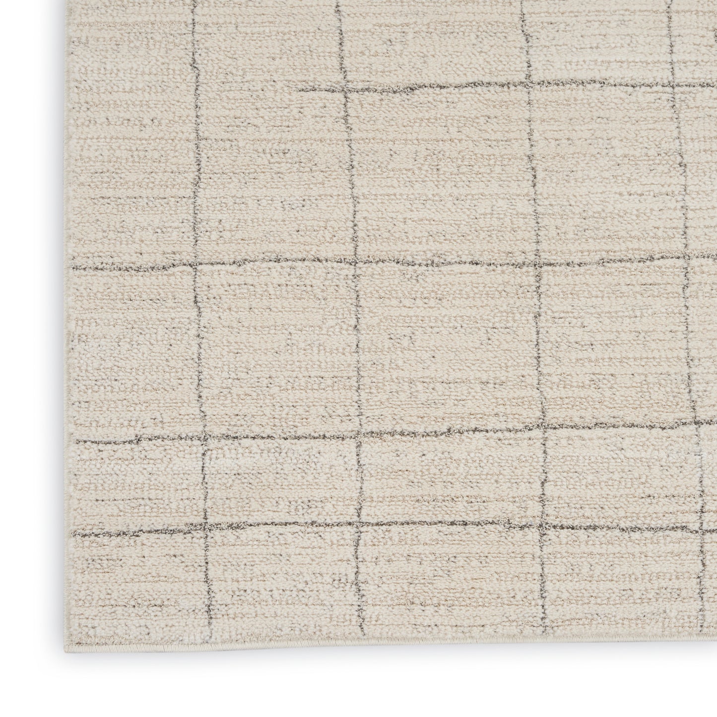 Beige woven rug with a subtle gray grid pattern; soft tufted texture and square-check design (corner view).