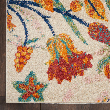 Cream shag area rug with bright orange, teal, and red floral pattern; thick tufted pile on dark wooden floor.
