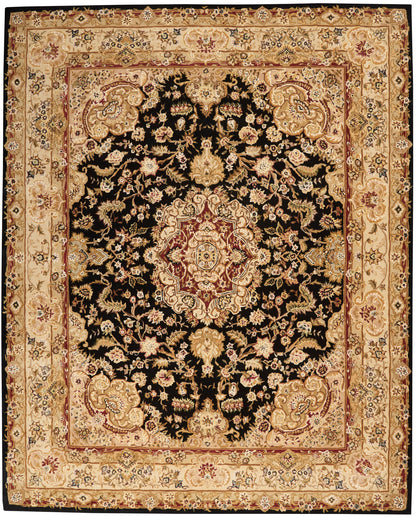 Persian-style rug with black field, ornate central medallion and gold floral motifs, beige-gold border, red inner border.