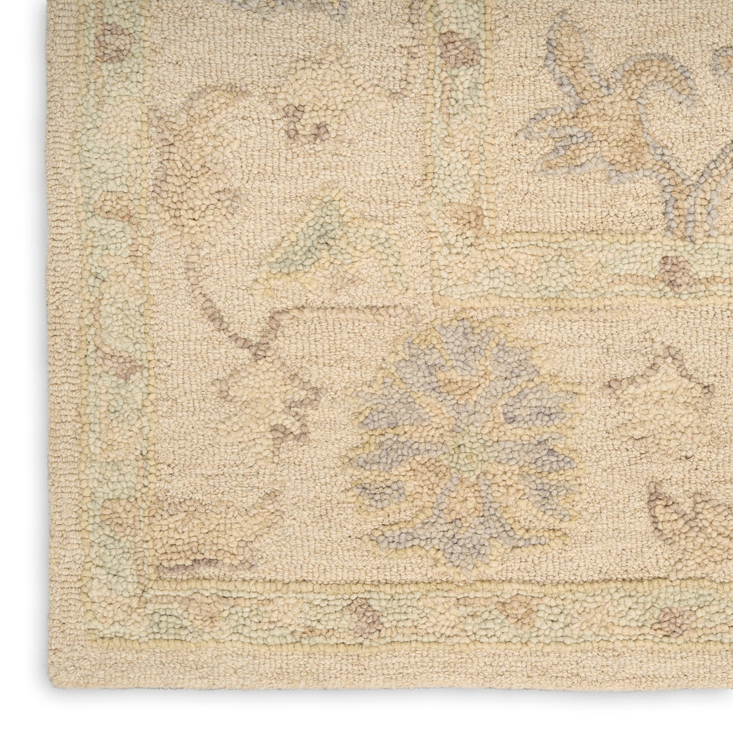 Beige rectangular rug with pastel-blue floral motifs and pale green border; textured woven pile, traditional oriental style.