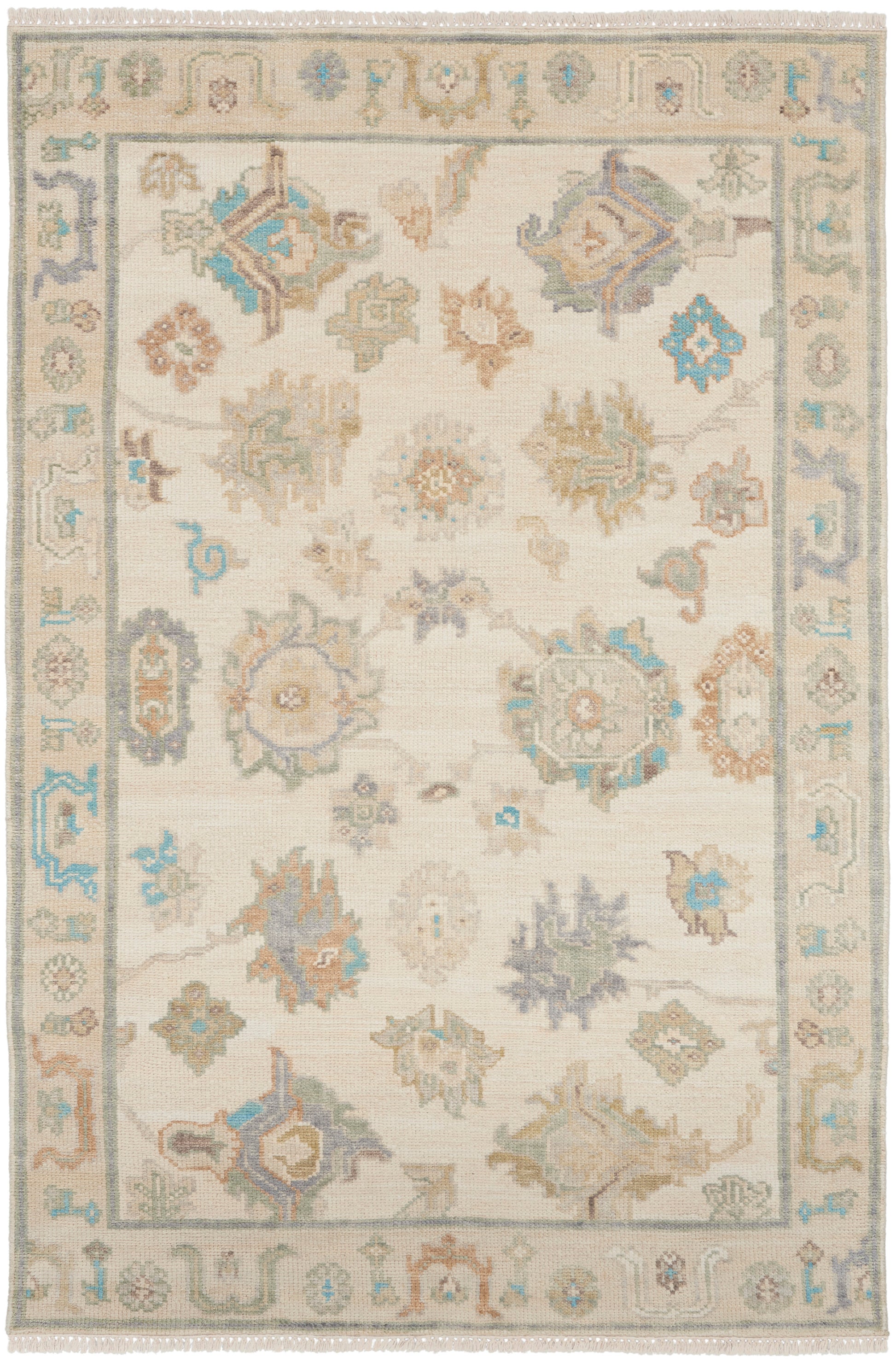 Soft beige oriental area rug with pastel blue, sage, taupe floral medallions and a bordered pattern; fringe edges.