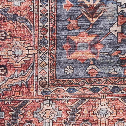 Close-up of a red & blue Persian-style oriental rug with floral motifs, woven texture, decorative floor covering.