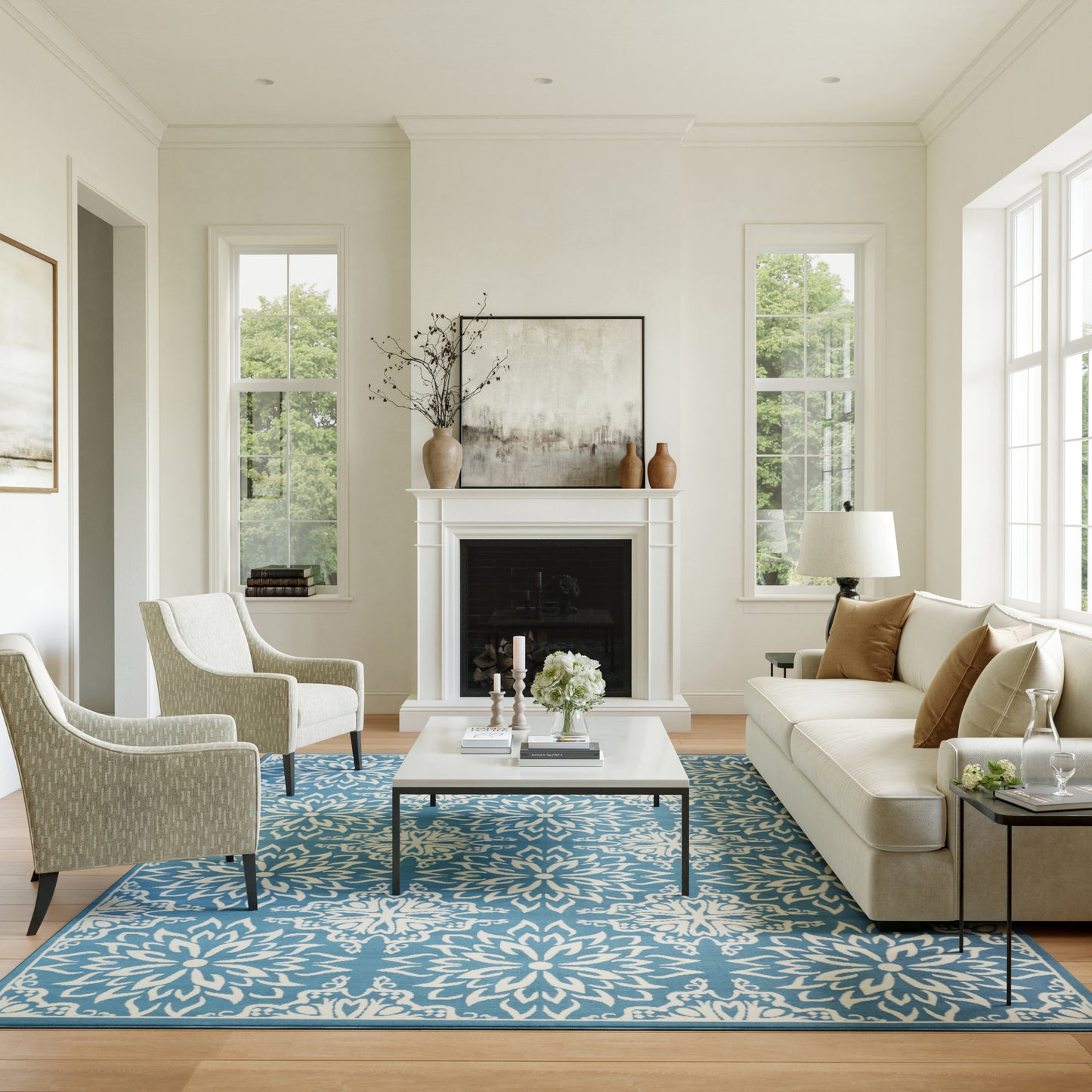 Blue floral rug in a cream living room with a beige sofa, two patterned armchairs, and a white coffee table by a fireplace mantel (6' x 9').