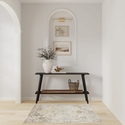 Black two-tier console table in an arched alcove with vase, greenery, wicker basket, framed art, and a neutral rug.
