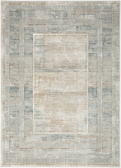 Soft blue-gray area rug with a beige center and cream geometric borders in a distressed vintage style.