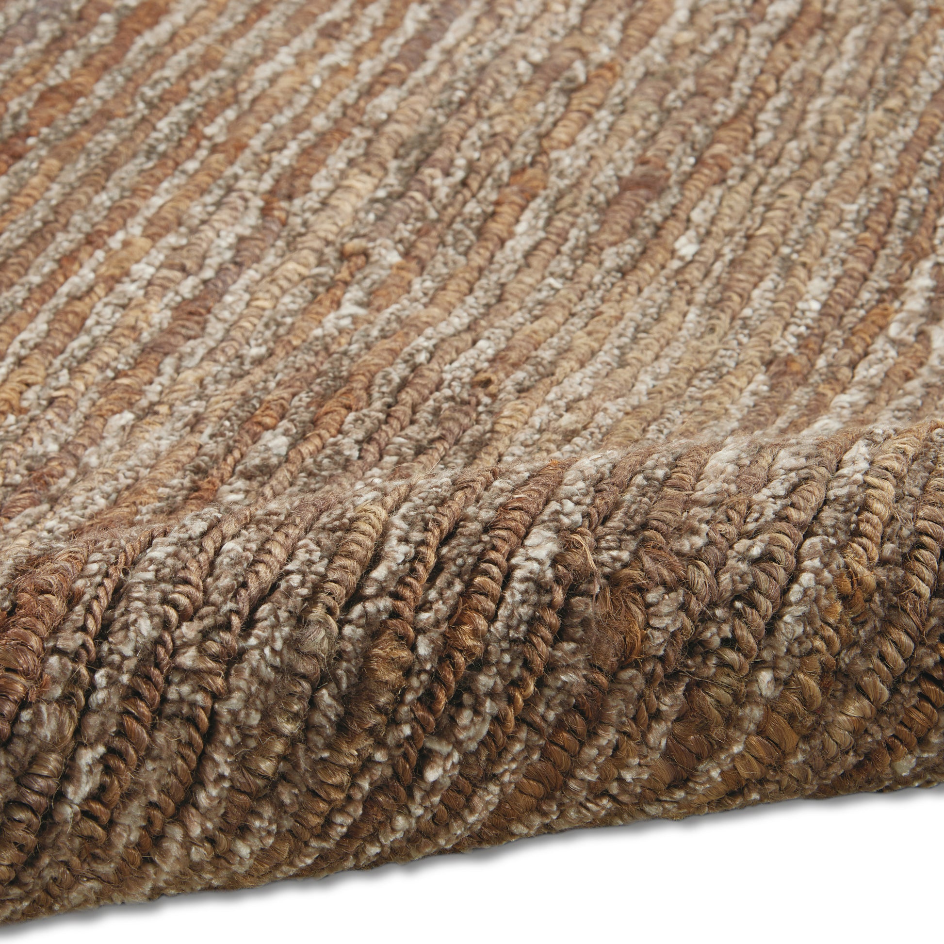 Close-up of brown, tan and cream shag rug with dense looped pile; warm earthy tones for cozy living space.