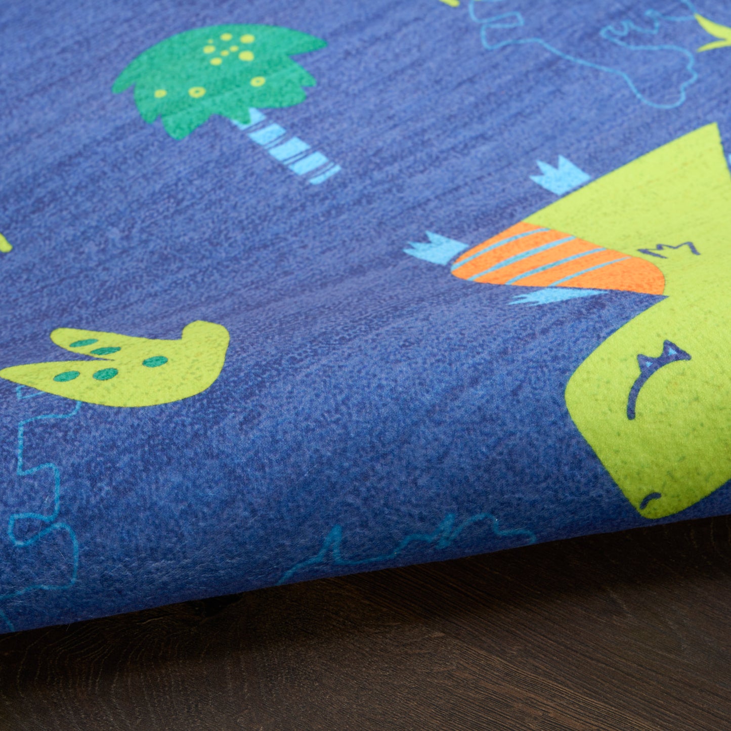 Blue kids' rug with lime-green dinosaur, palm tree and bird prints, and orange striped details