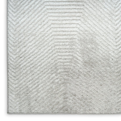 Soft light-gray shag rug with subtle chevron pattern and plush pile for modern living room decor.