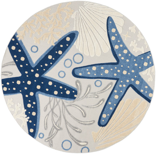 Round coastal rug featuring two dark blue starfish with white spots, beige shells & coral on light gray background.