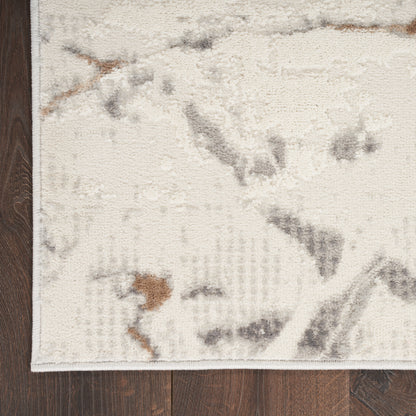 Ivory abstract area rug with gray & brown accents; cropped edge visible on dark wooden floor.