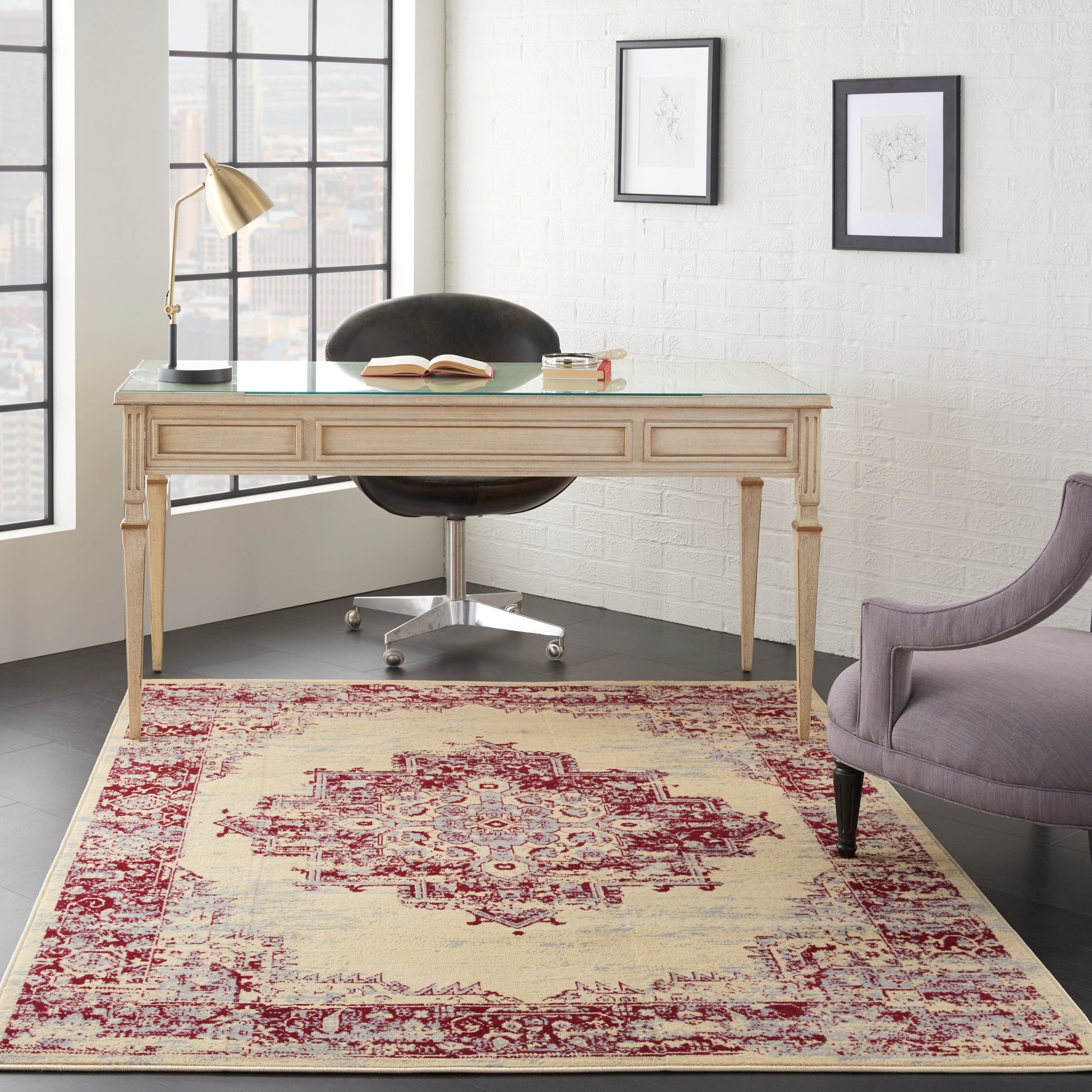 Glass-top wooden desk with ornate legs, brass lamp, open book, black swivel chair; lavender armchair, botanicals, city view.