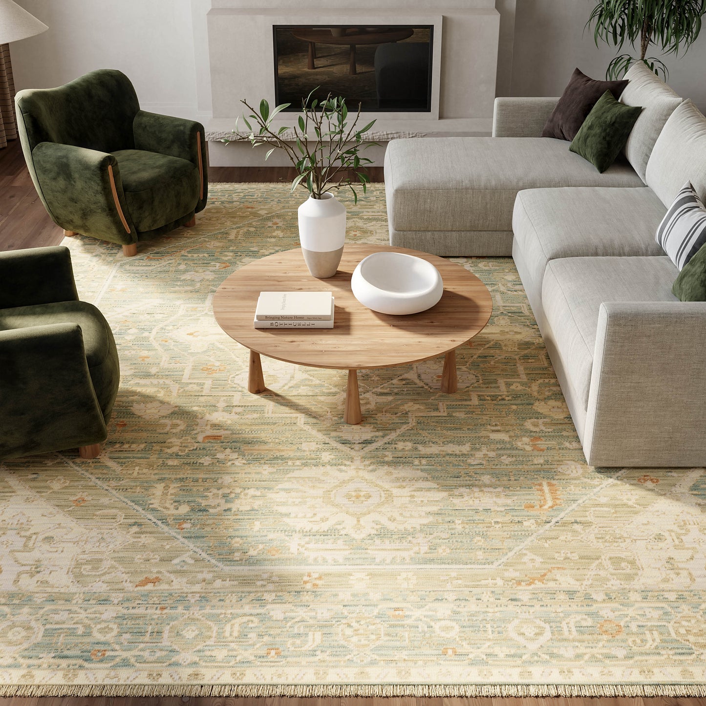 Cozy living room with round wooden coffee table, beige sectional sofa, green velvet chairs, patterned rug, and plants.