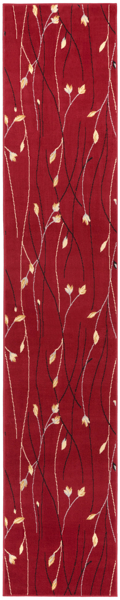 Red narrow runner rug with white and black branchlike vines and small yellow leaves.