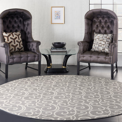Round grey swirl-pattern rug (8' round) on the floor, flanked by two dark brown tufted leather armchairs with nailhead trim and a glass round coffee table.