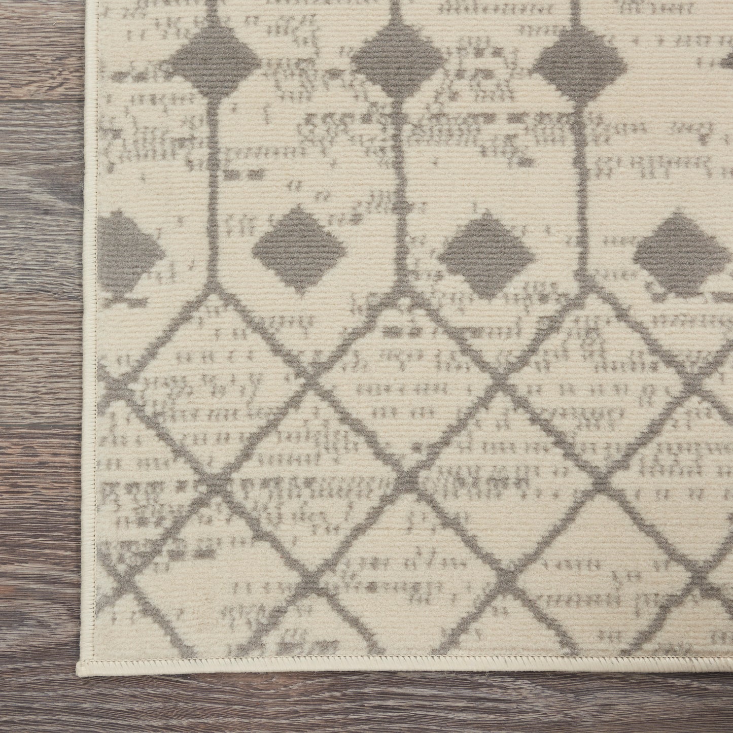 Rectangular cream flatweave rug with gray diamond lattice pattern; modern geometric style for living spaces.