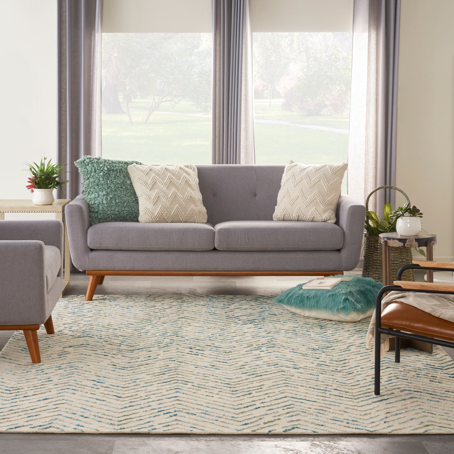 Grey modern rug with blue-cream pattern, 8' x 12'.