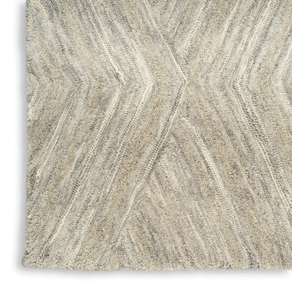 Beige chevron-pattern rug with textured loop pile in cream and taupe tones.