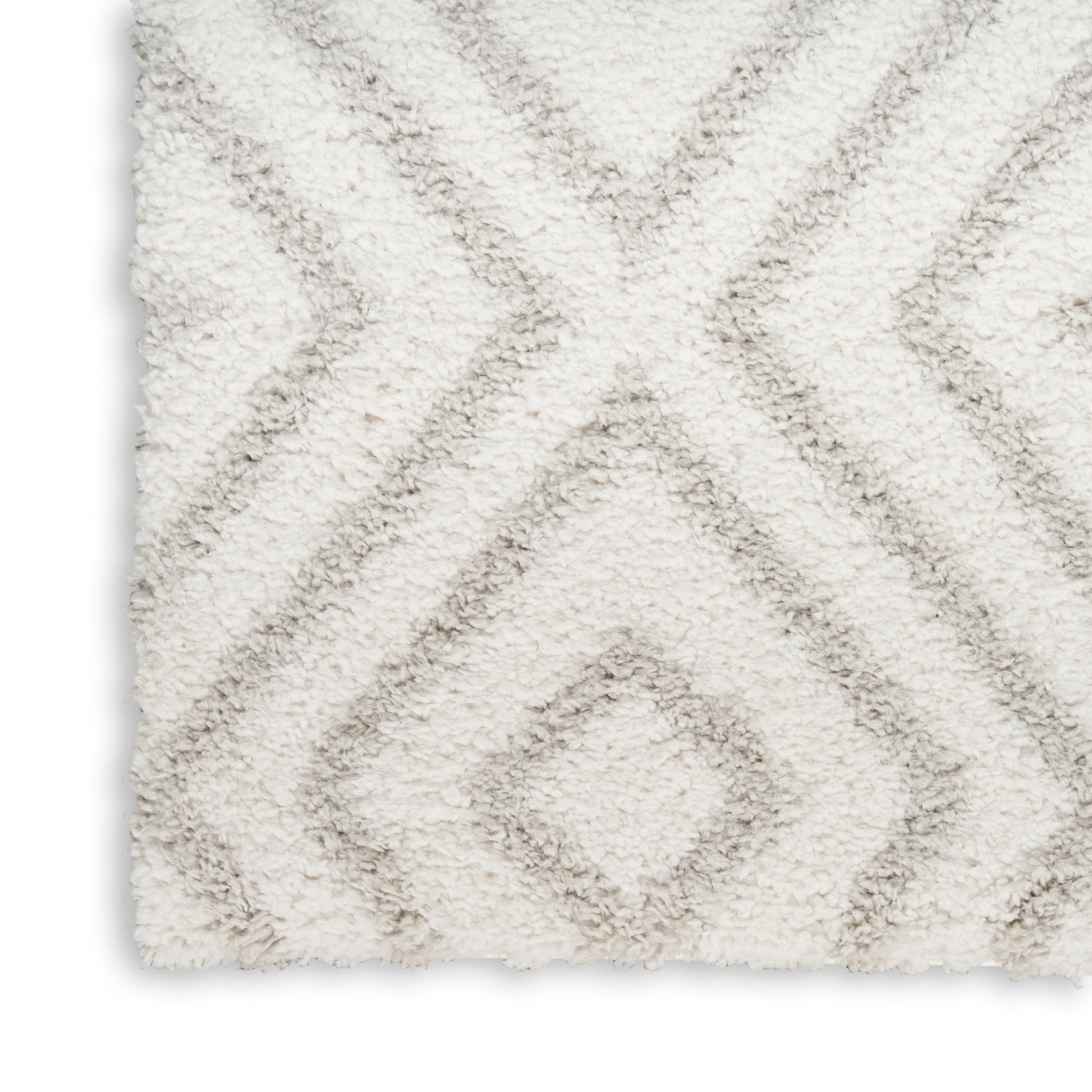 Cream shag rug with plush pile and light gray diamond lattice pattern.