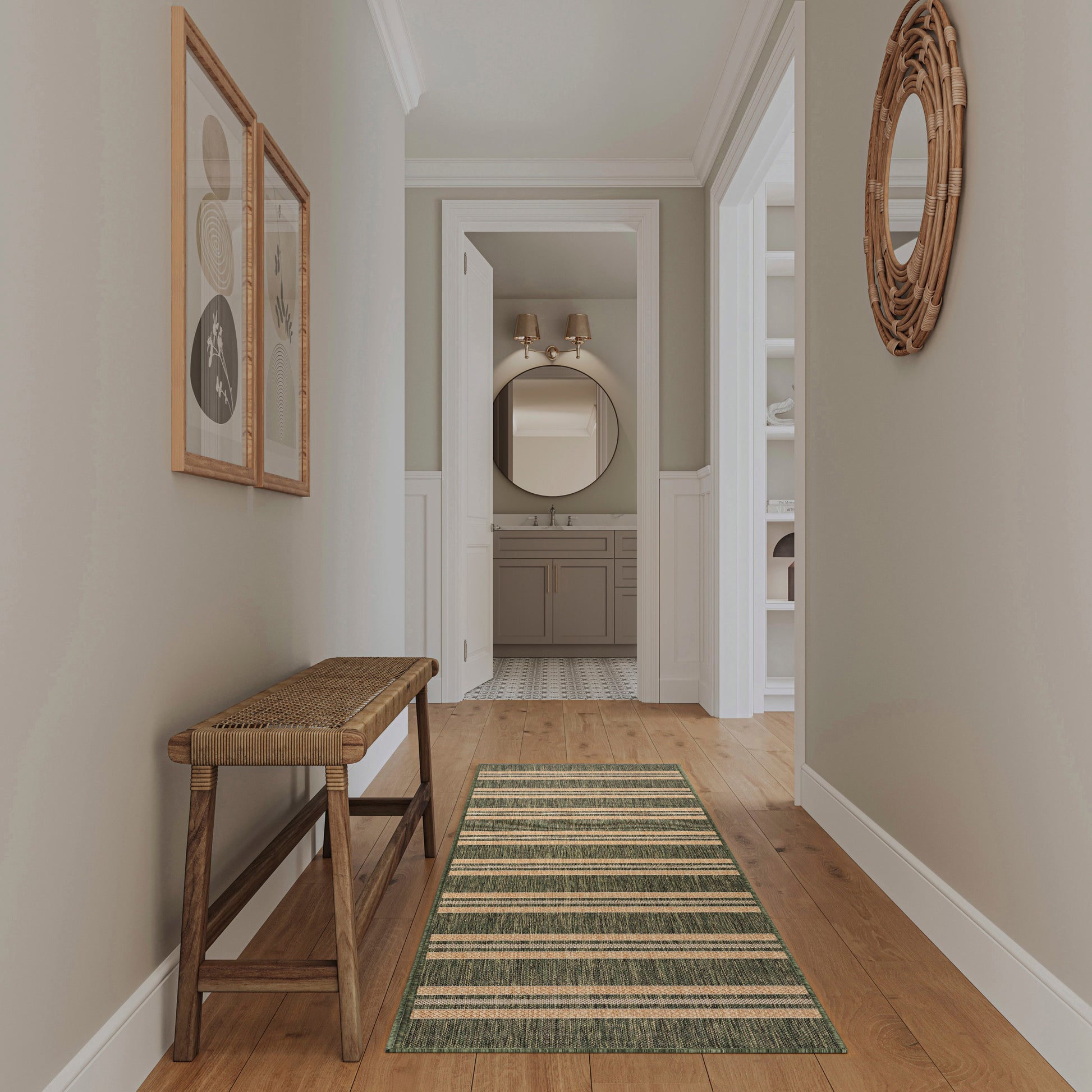 Rustic hallway with wooden bench, green striped runner rug, beige walls, wicker round mirror, framed art.