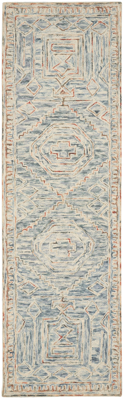 Long runner rug in pale blue and ivory with rust accents; geometric medallions and diamond borders, distressed vintage look.