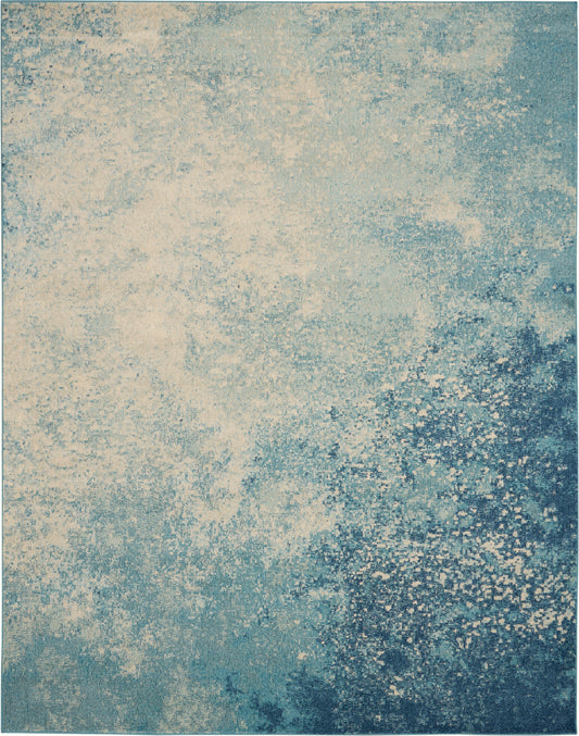 Rectangular blue-teal and cream rug with a speckled, abstract gradient texture for modern living rooms.