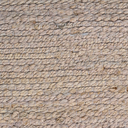 Natural jute rug close-up, beige woven texture with knotted loop pattern; rustic coastal floor mat.