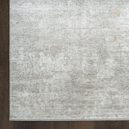Light gray distressed area rug with subtle beige undertones on dark wooden floor; rectangular, low-pile.